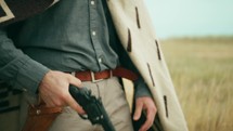 Cowboy swings gun in hand
