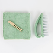 vintage clothespins, mint towel, and brush on white background 