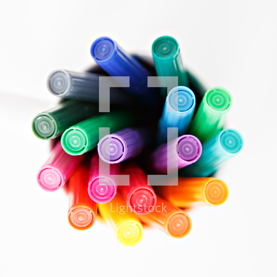 markers in a cup on a white background 