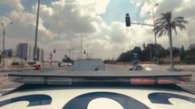 Timelapse of Police car with blue and red lights driving fast through city streets