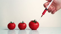 Injection into fresh red tomato.