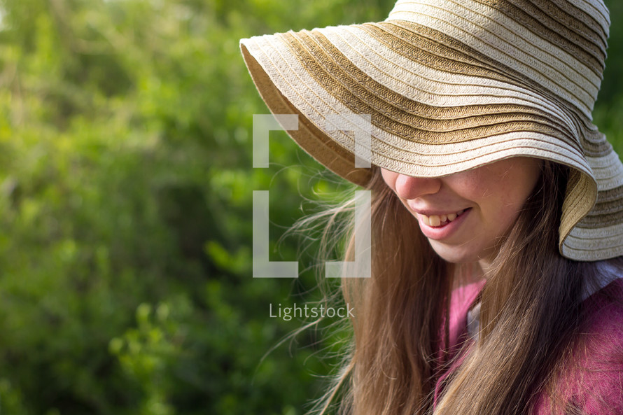 smiling girl in a straw hat 
