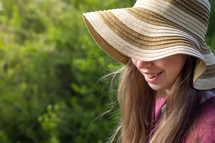 smiling girl in a straw hat 