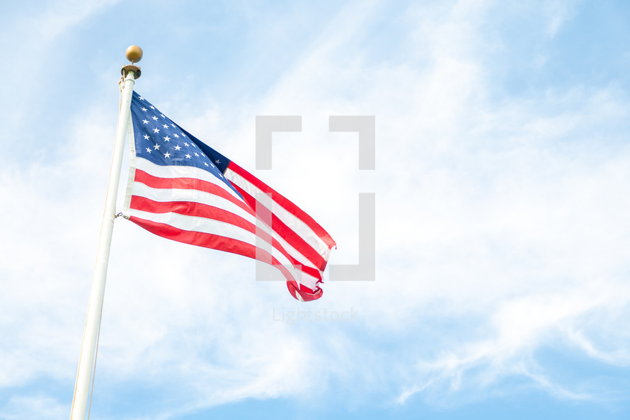 american flag waving against sky