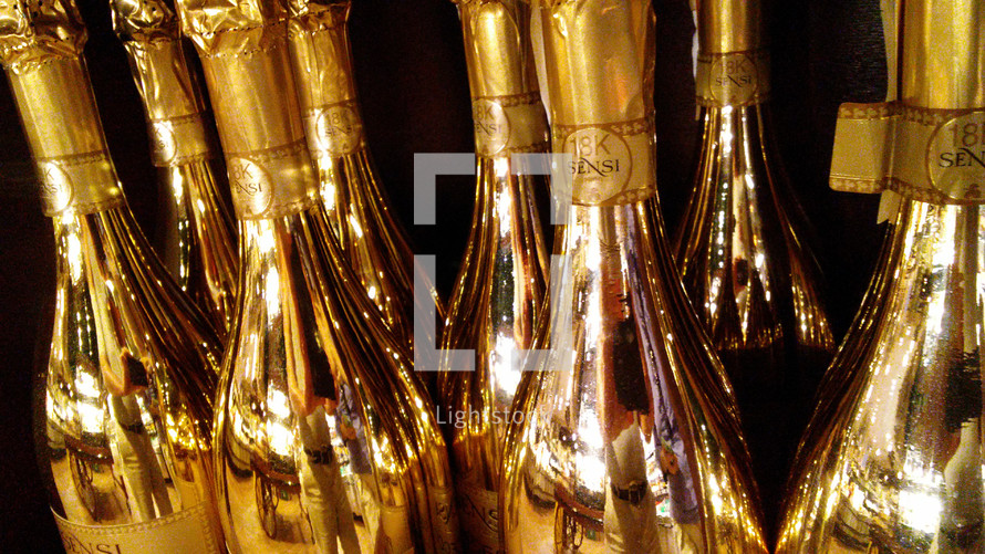 A collection of shiny wine and champagne bottles are decorated and ready to open to celebrate the New Year in style for New Year's Eve celebrations and toasting friendships, memories and a bright and hopeful future for the upcoming new year. 
