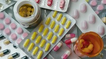 Close-Up of Pills and Tablets Falling Down on the Table with Medications
