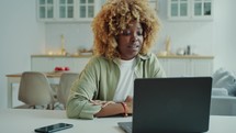 Young Black Woman Speaking via Video Call on Laptop at Home
