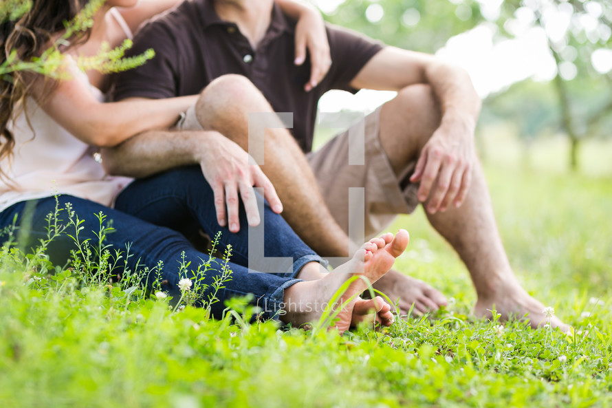 couple sitting in green grass