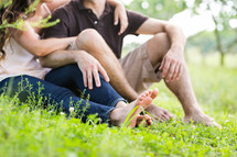 couple sitting in green grass