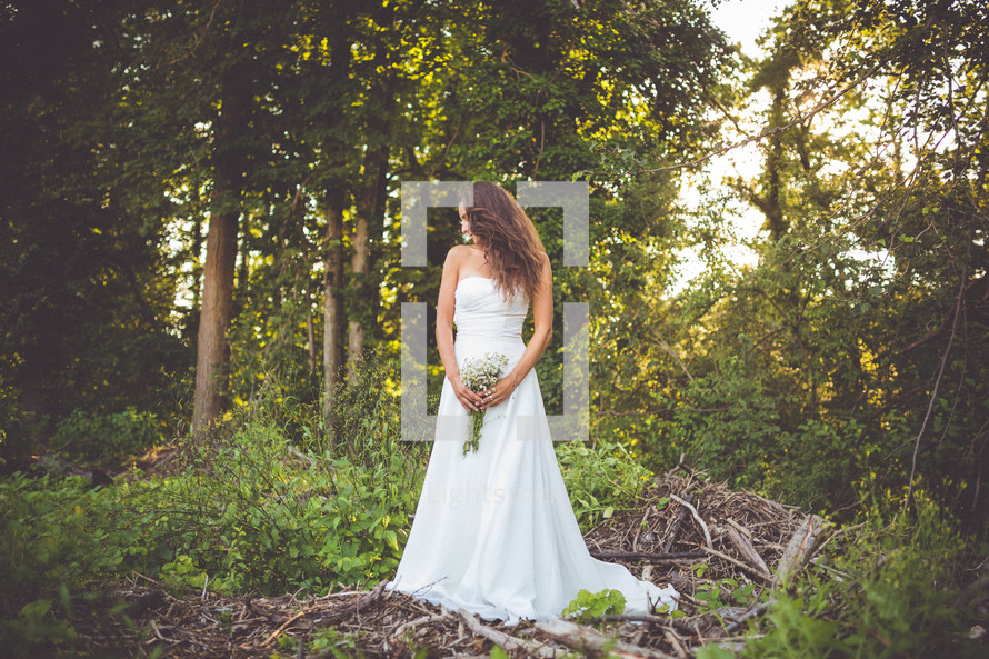 portrait of a bride standing in a forest 