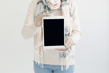a woman holding a tablet