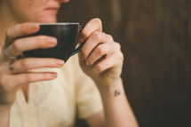 woman holding a cappuccino cup