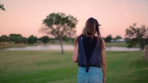 Woman Reading Bible and Journaling Outside at Sunset