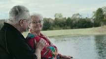 elderly couple talking outdoors 