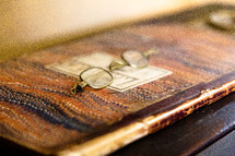 Antique glasses on old book