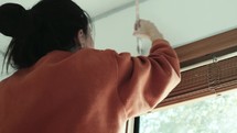 woman painting the walls of her house 