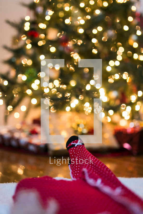 baby lying under a Christmas tree 