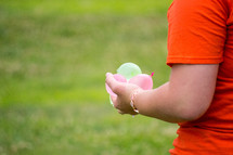 a person holding water balloons 