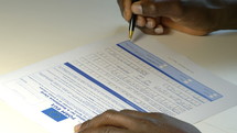 a man filling out documents 