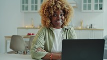 Portrait of Positive African American Woman with Laptop at Home
