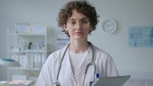 Portrait of Young Female Physician with Digital Tablet in Clinic
