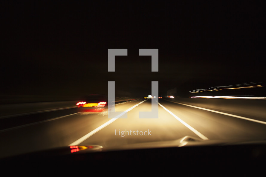 A car driving on a motorway at night