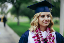 a smiling graduate wearing a Hawaiian Leis 
