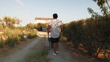 Man Carrying A Wheelbarrow To The House 