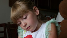 An adorable young girl concentrating on drawing pictures