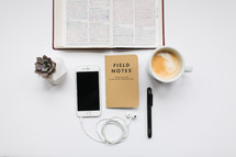 open Bible, white background, pages, succulent plant, mug, coffee, latte, field notes book, pen, desk, bible study 