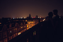 a couple on a balcony at night 