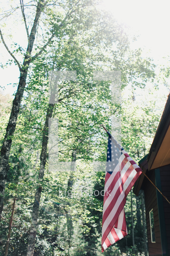American flag on the side of a cabin 