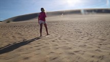 a girl walking in the desert 
