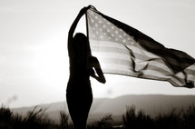 silhouette of a young woman with an American flag 