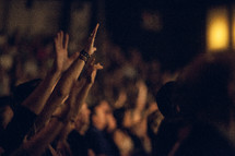 Audience with hands raised in worship.