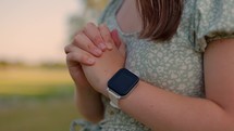 Girl Praying Outside at Sunset