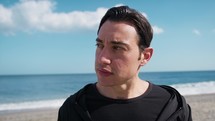 Man Sad Looks Left And Right On The Beach Near The Sea