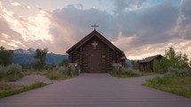 Old Wooden Chapel in the Mountains at Sunset