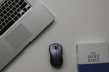 NIV Holy Bible, mouse, and laptop 