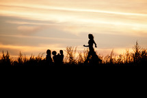 children running at sunset 