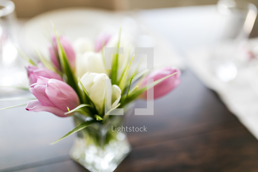 tulips in a vase on a set table for Easter 