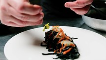 Chef Plating Black Ink Squid Italian Spaghetti Pasta Food At Restaurant