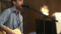 worship leader singing into a microphone 
