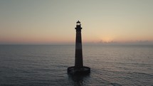 A lighthouse on the  Atlantic Ocean coast of South Carolina during sunrise 