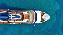 Aerial view of the cruise ship in open water. Passenger cruise ship sailing in ocean top view from above. Large luxury cruise liner deck. 