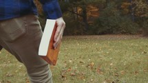a man carrying a Bible 
