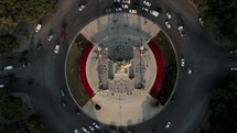 Top View Of Vehicles Driving At Roundabout On Paseo de la Reforma With Angel of Independence In Mexico City. - aerial ascend
