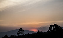 sun setting behind the mountains in Kenya