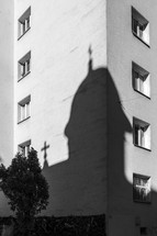 A church shadow on a residential building.
