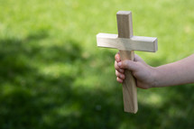 a child holding a cross 